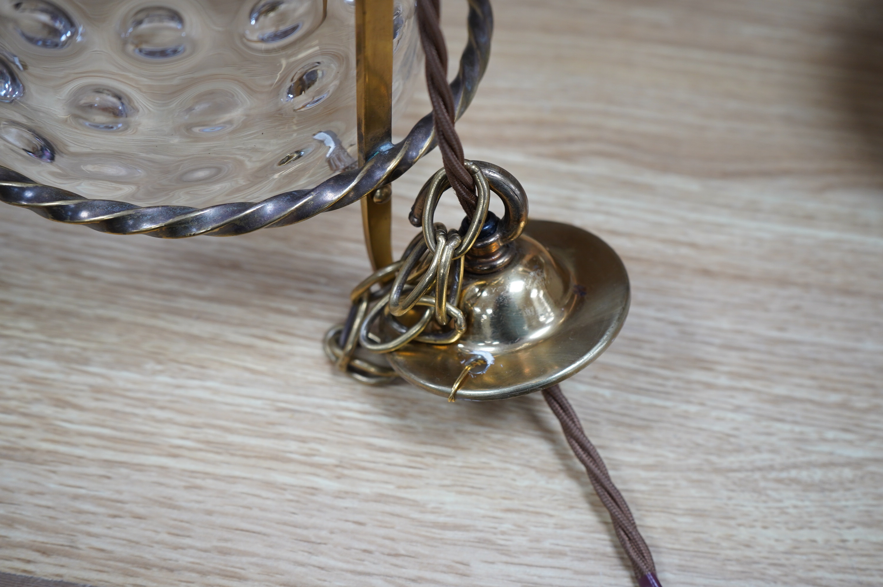 An English Art Nouveau brass lantern with wavy bubbly glass cylinder, c.1910-1920's, including chain and ceiling rose, wired, lantern 34cm high, diameter 13.5cm, glass 16.5cm high. Condition - glass shade a little loose